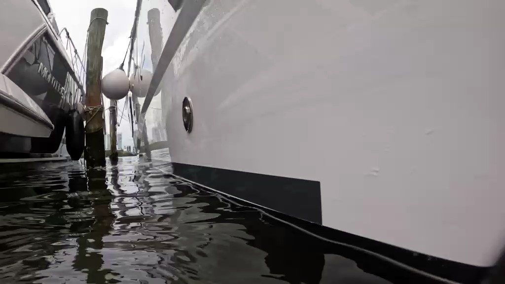 The same hull clean and white at the waterline after the service